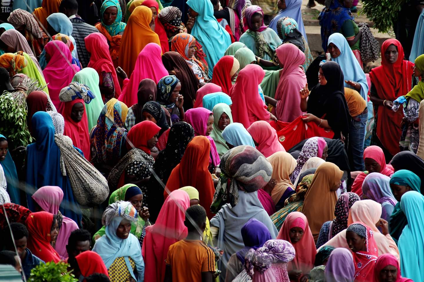 A bustling market scene in Harar with people and goods